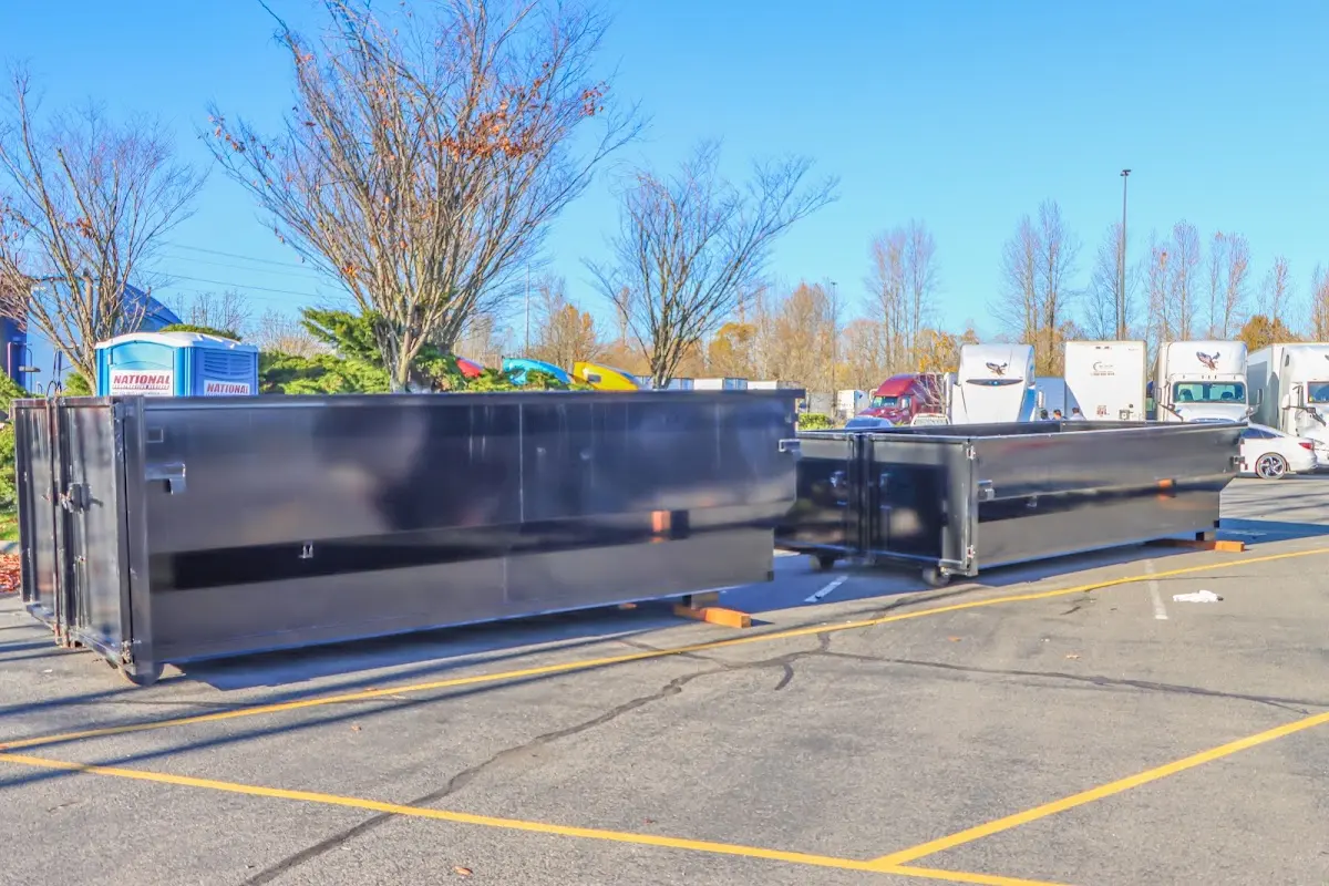 Professional dumpster rental service with roll-off container on residential driveway in Dowagiac